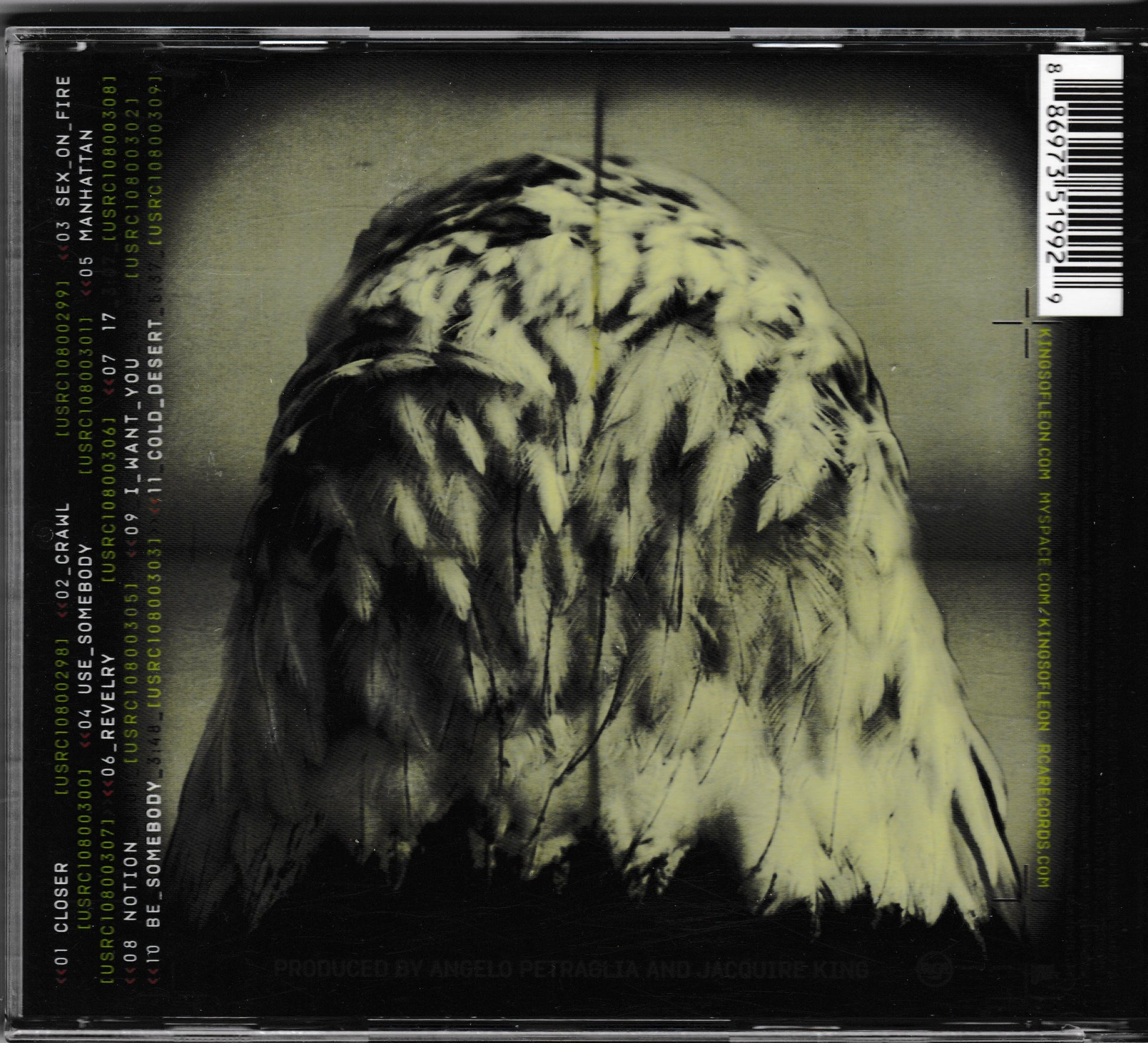 The back cover of a CD case for the band Kings Of Leon, featuring a dark, moody photograph of a bird of prey's feathers in high-contrast black, white, and yellow-green tones. The left side displays a tracklist with track titles and artist names in a light greenish-yellow font, and a barcode is visible on the right side.
