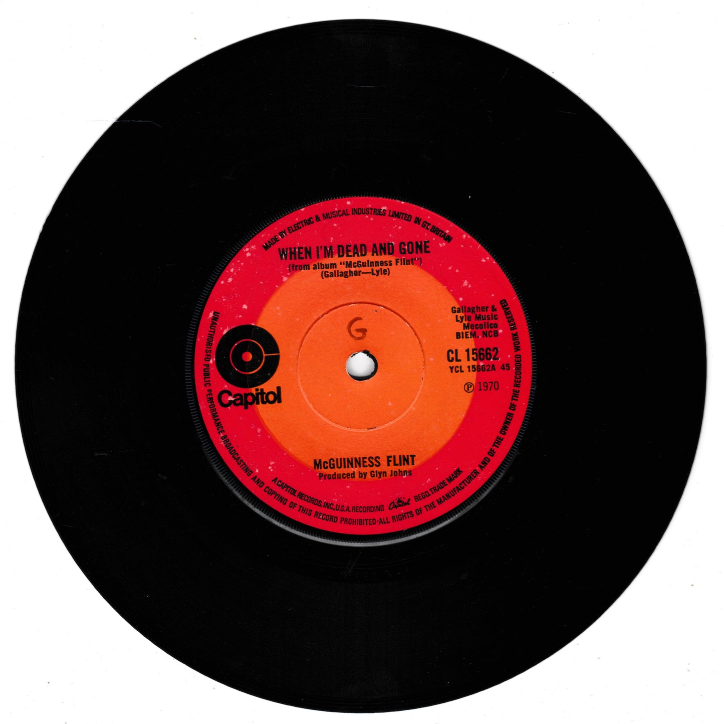 A black vinyl record featuring a bright red and orange centre label with the Capitol logo and the song title 'When I'm Dead and Gone' by McGuinness Flint, shown on a plain white background.