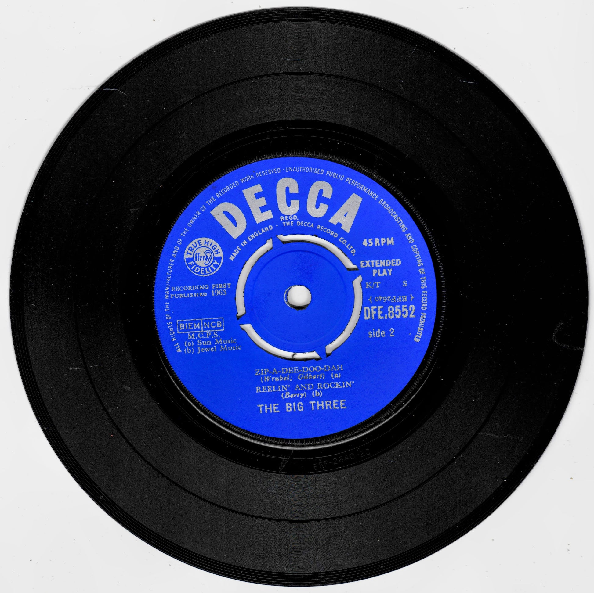 A black 7-inch vinyl record with a bright blue centre label reading 'DECCA' and 'The Big Three', photographed on a plain light background.