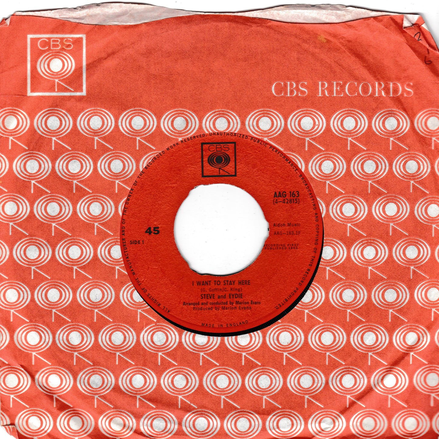 CBS Records 45 rpm vinyl record sleeve and centre label for 'I Want to Stay Here' by Steve and Eydie, featuring a terracotta orange and white target pattern.