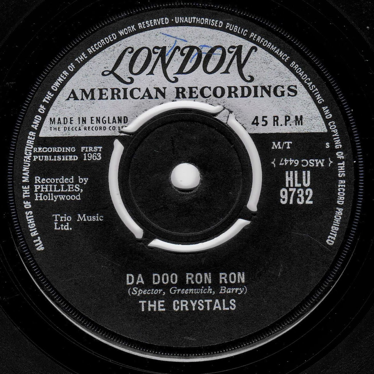 A close-up of a vintage vinyl record label for London American Recordings, featuring the song 'Da Doo Ron Ron' by The Crystals. The black record has a white and gray label with black text.