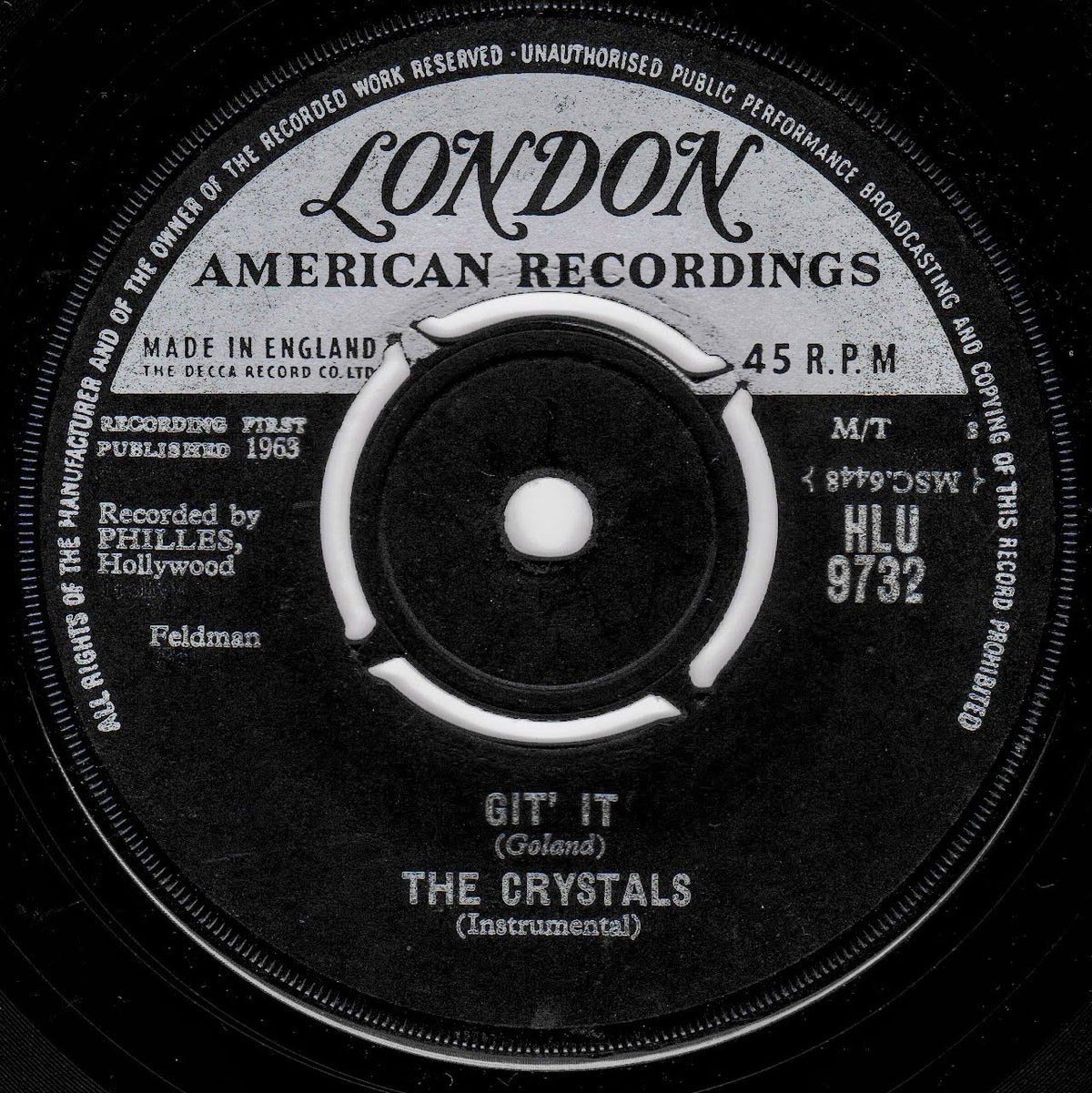 A black-and-white close-up of a vintage 45 RPM record label reading London American Recordings, with the title 'Git' It (Goland) The Crystals (Instrumental)' visible on the label.