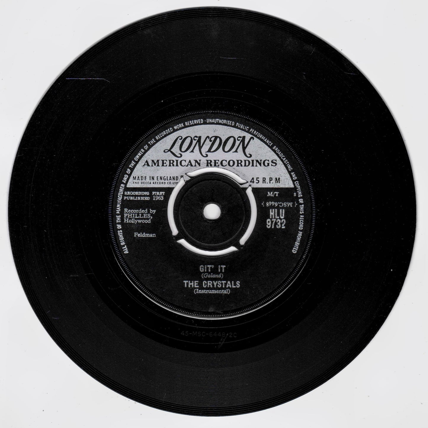 A black 45 RPM vinyl record from London American Recordings, featuring the label 'Gift It' by The Crystals, shown against a plain white background.
