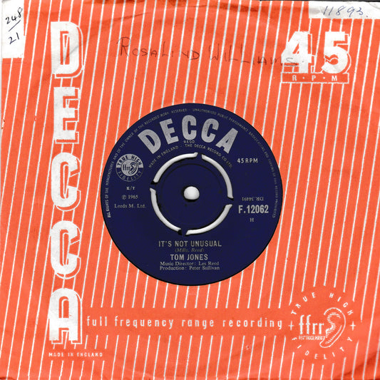 A vintage Decca 45 rpm record sleeve for Tom Jones' single 'It's Not Unusual', featuring a bright orange and white striped design with a blue central label.