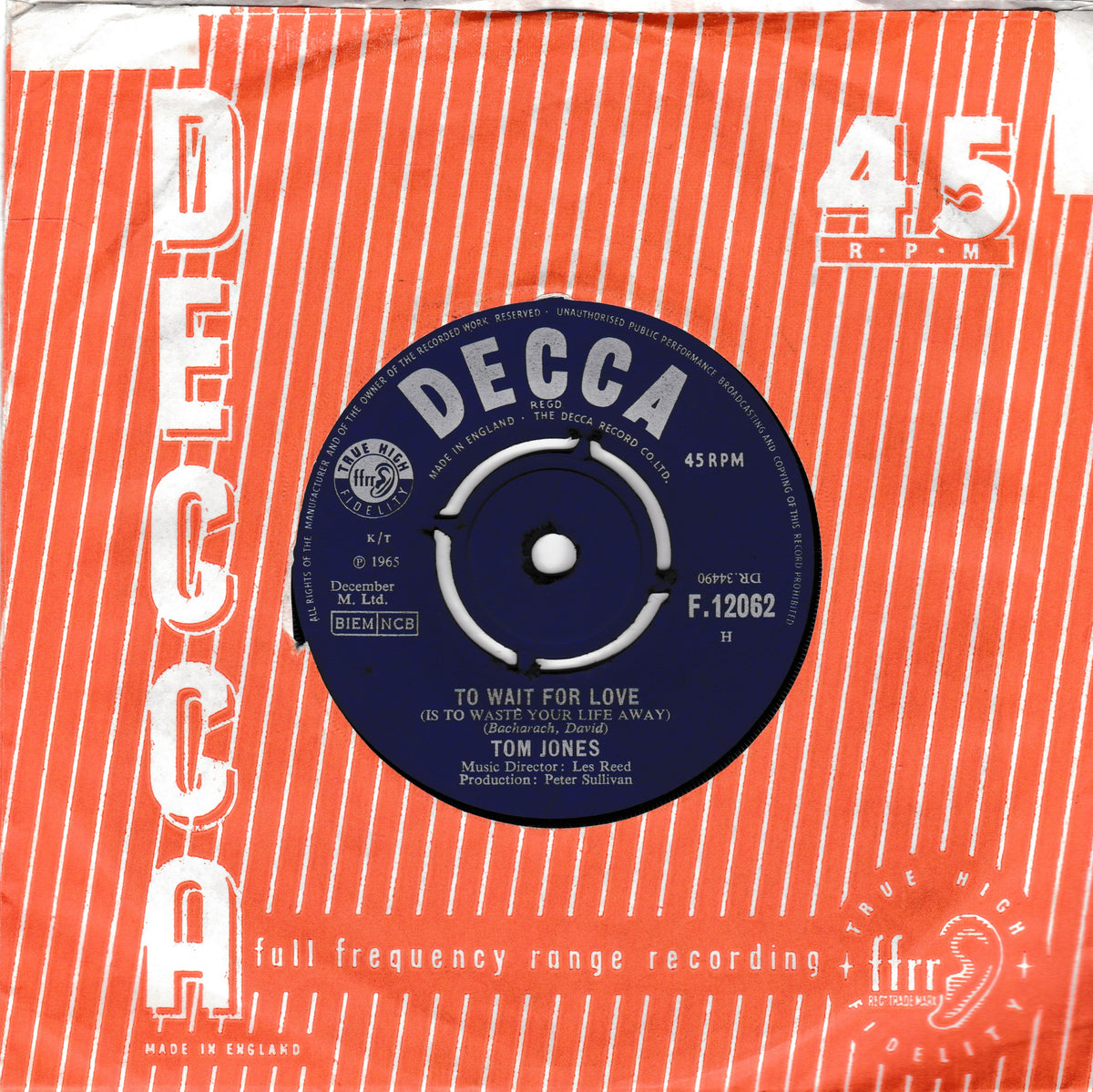 A vintage 45 RPM record sleeve for Tom Jones' 'To Wait For Love' on Decca Records. The sleeve features a bold orange and red striped design with white text, and the central blue vinyl record is clearly visible.