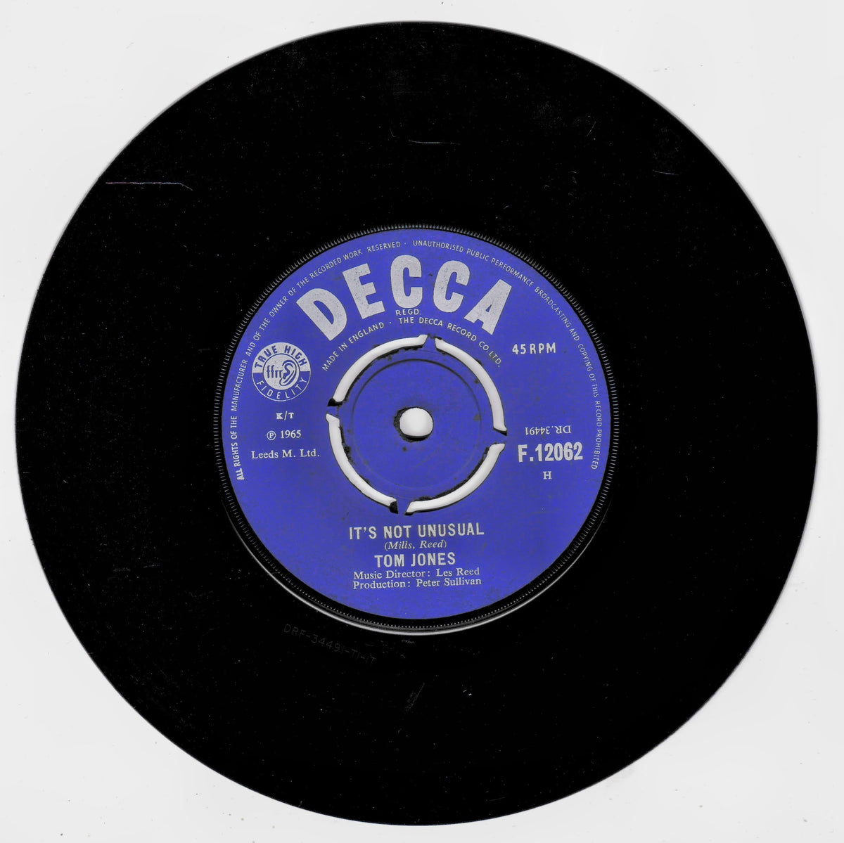A black 45 RPM vinyl record with a blue and white DECCA label featuring Tom Jones's song 'It's Not Unusual'.