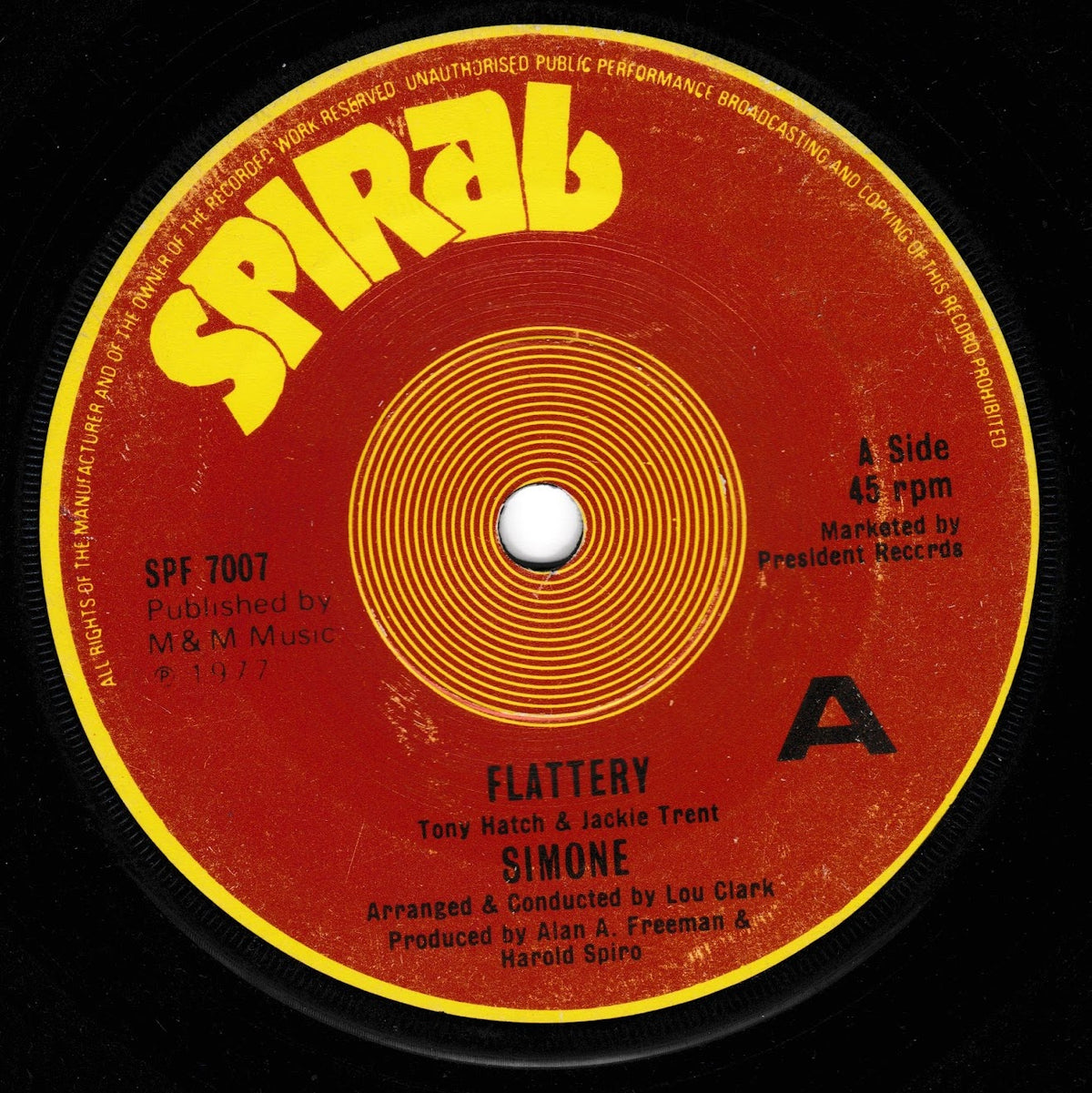 A vintage 45 rpm vinyl record label for Simone's 'Flattery' with a red and yellow design, photographed against a black background.