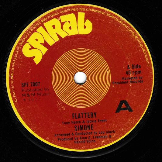 A vintage 45 rpm vinyl record label for Simone's 'Flattery' with a red and yellow design, photographed against a black background.