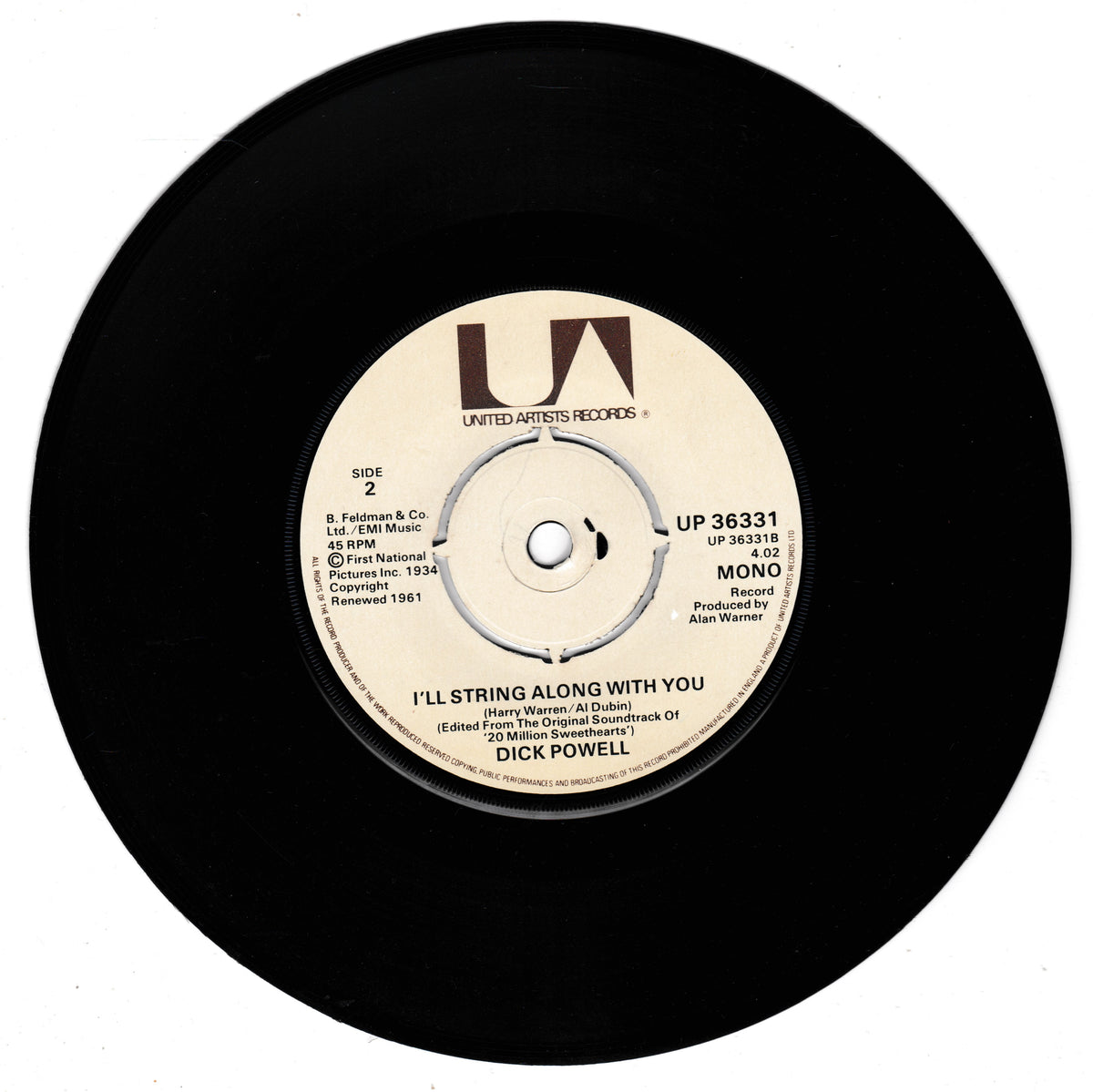 A black vinyl record with a cream-coloured centre label for Dick Powell's 'I'll String Along With You' on United Artists Records.