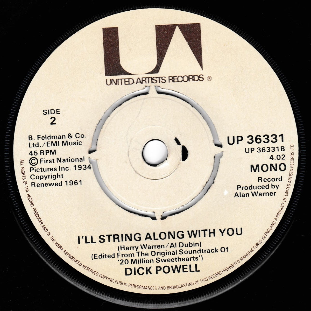 A close-up of a vinyl record label for Dick Powell's 'I'll String Along With You' on United Artists Records. The cream-colored label features black text and a prominent brown 'UA' logo, with the 'MONO' designation and catalog number UP 36331 visible.
