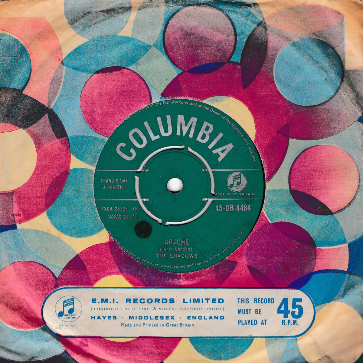 Vintage Columbia 45 rpm record sleeve for 'Apache' by The Shadows, featuring a colorful mid-century retro pattern of overlapping circles in pink, teal, yellow, and black, with a green Columbia label and a blue E.M.