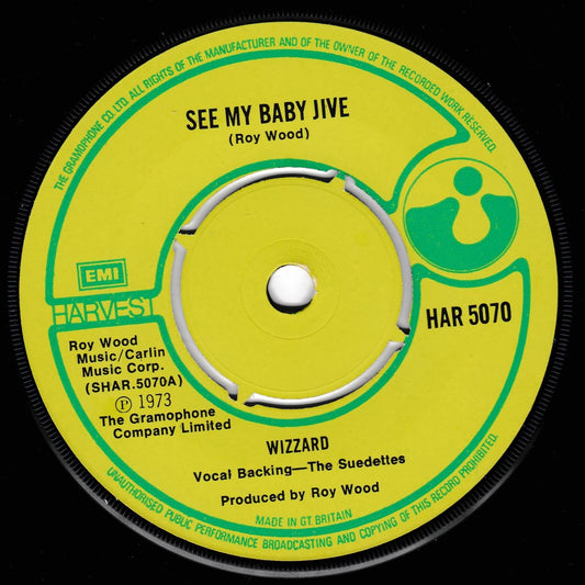 A vintage 1973 45 single record label for Roy Wood's 'See My Baby Jive' and 'Wizzard', featuring a bright yellow-green centre label with green and black text on a black vinyl background.