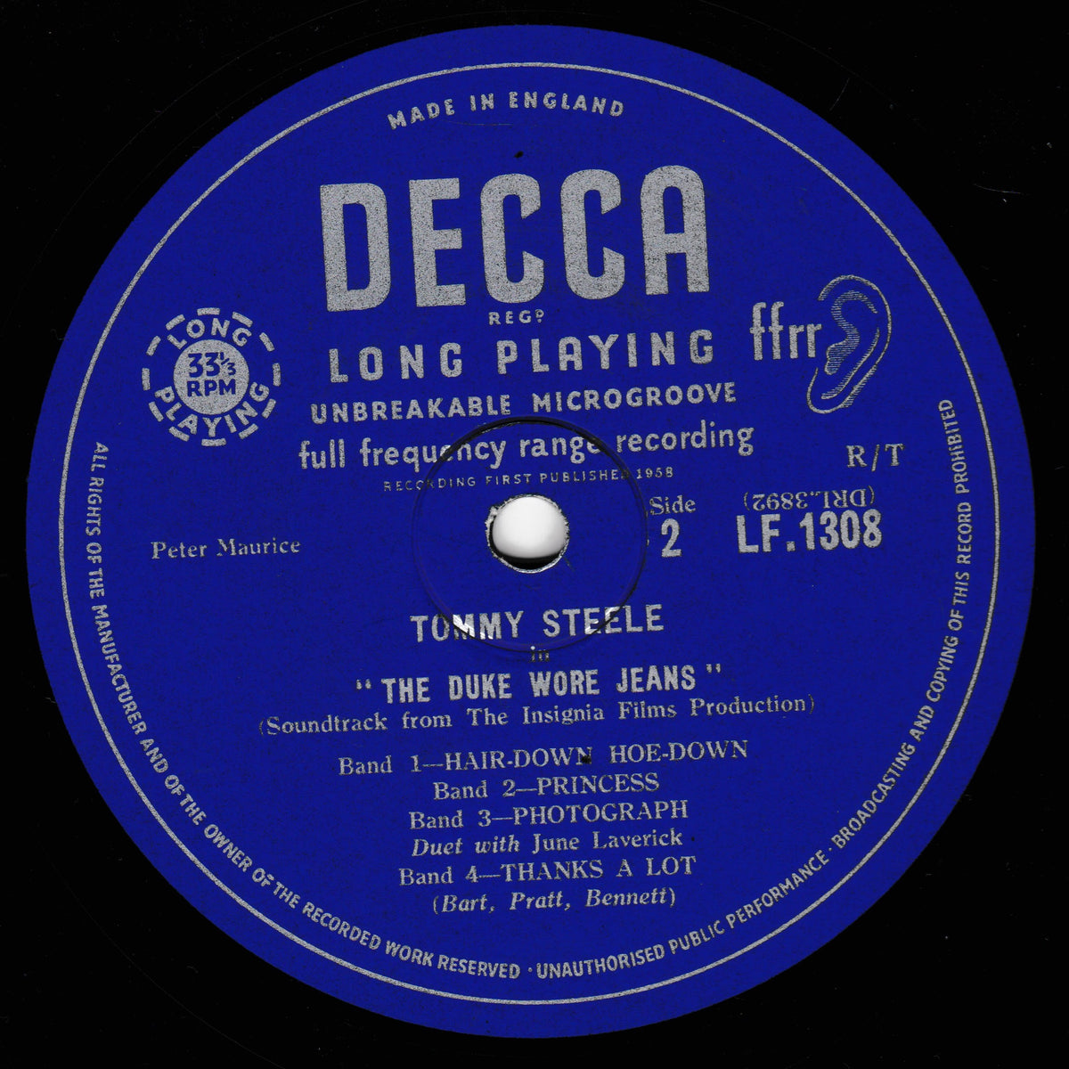 A blue DECCA vinyl record label for Tommy Steele's 'The Duke Wore Jeans', showing the record's details including the artist name, track list, and manufacturing information.