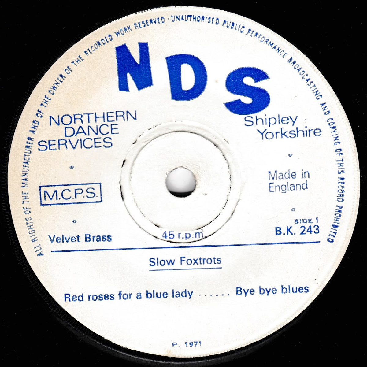 A vintage 45 rpm vinyl record label for NDS 'Slow Foxtrots' by Velvet Brass, featuring a white label with blue text and a black vinyl edge.