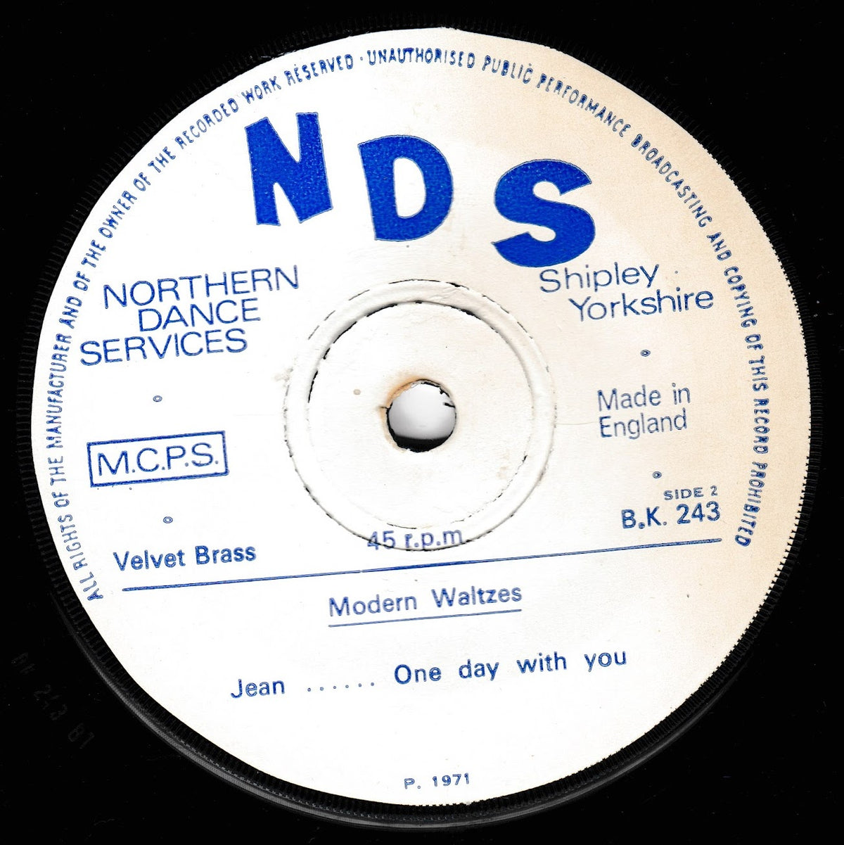 A close-up of a vintage 45 rpm vinyl record label for NDS Records, featuring the title 'Modern Waltzes' and tracks 'Jean - One day with you'. The white label has blue text and is set against a black vinyl background.