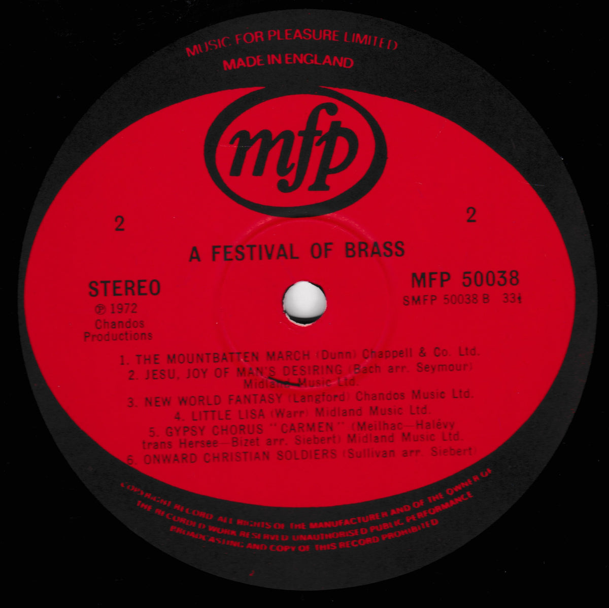 A close-up of a vinyl record label for MFP 'A Festival of Brass' on a black record. The label is bright red with black text and the MFP logo, listing track titles and copyright details.