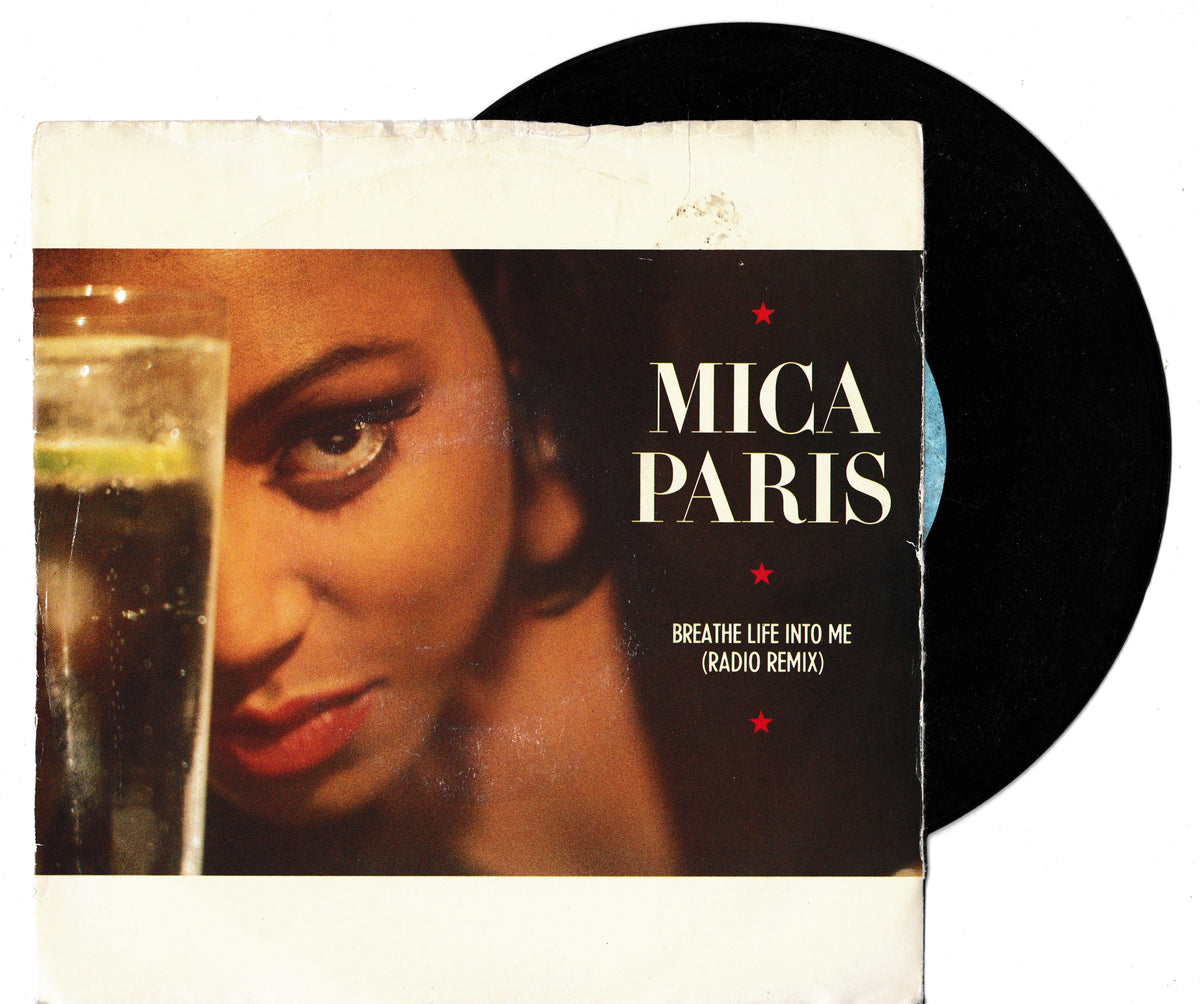 A vinyl record partially pulled from its sleeve, featuring Mica Paris's 'Breathe Life Into Me (Radio Remix)'. The sleeve has a vintage, distressed design with a close-up photo of the artist and a glass of water, while the black vinyl record is visible behind it on a white background.