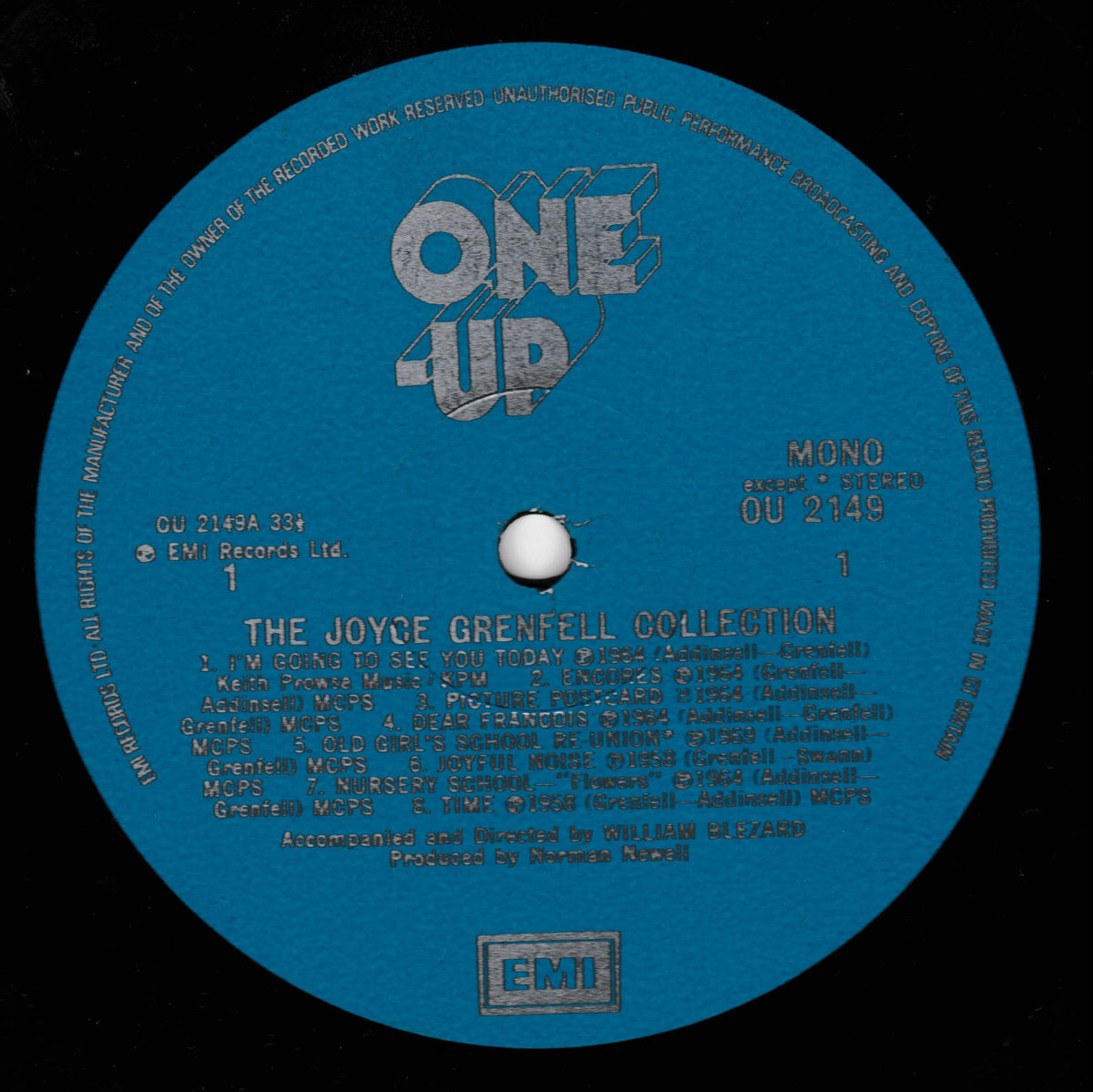 A blue vinyl record label for 'The Joyce Grenfell Collection' on a black background, with large silver 'ONE UP' text at the top and an EMI logo at the bottom.