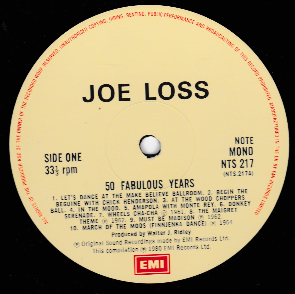 A close-up of a vinyl record label for Joe Loss's compilation '50 Fabulous Years', showing track listings, 33 1/3 rpm, and EMI Records branding on a black record surface.