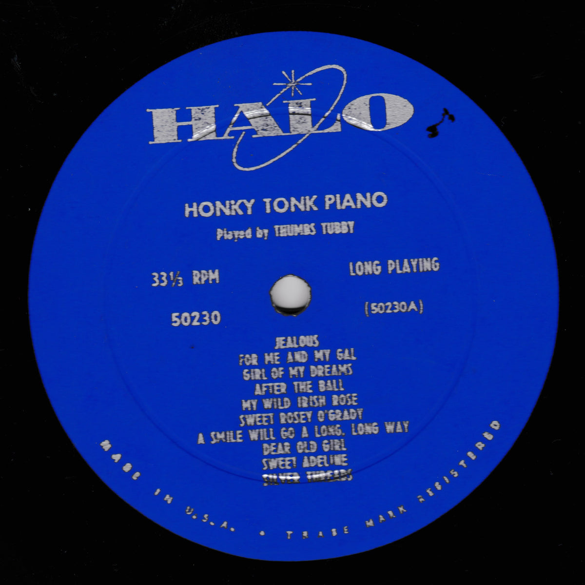 A blue vinyl record label with the HALO logo and white text reading 'Honky Tonic Piano' and 'Played by Thrumbs Tubbty,' photographed against a black background.