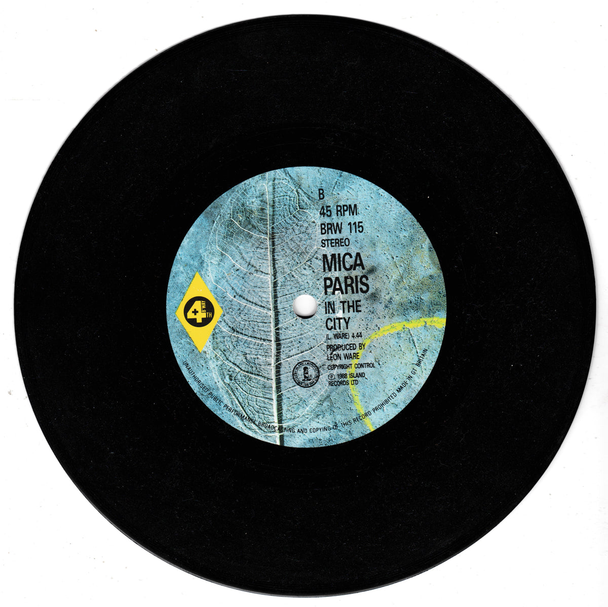 A black vinyl record with a light blue centre label reading 'MICA PARIS IN THE CITY' and a yellow diamond logo, photographed on a white background.