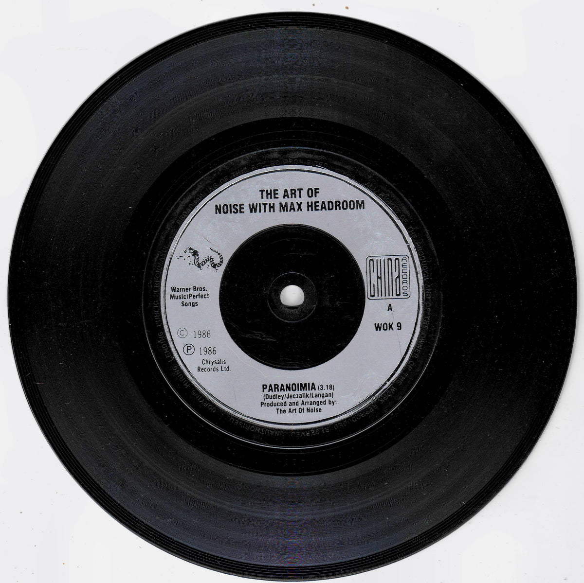 A black vinyl record with a white centre label reading 'THE ART OF NOISE WITH MAX HEADROOM' and 'PARANOIMIA', photographed on a plain white background.