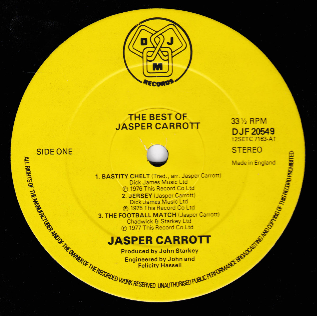 A bright yellow vinyl record label for Jasper Carrott's 'The Best of Jasper Carrott' on DJM Records, photographed against a black background.