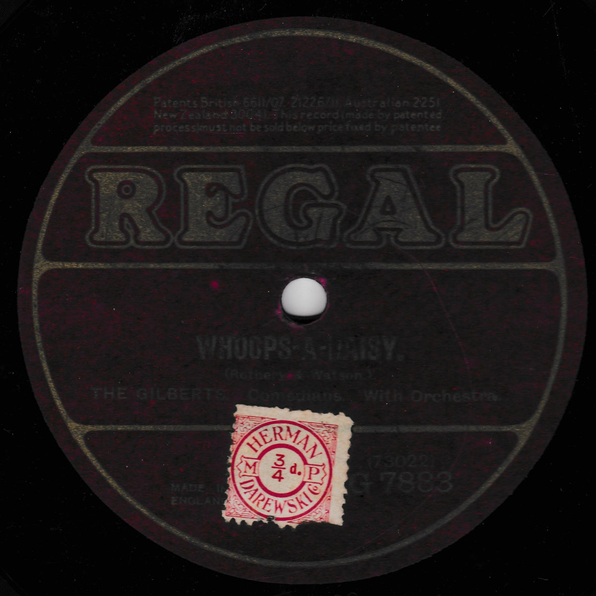 A vintage Regal 78rpm record label for 'Whoops a Daisy' by The Gilberts, featuring a black background with dark printed text and a red circular 78rpm speed record sticker.
