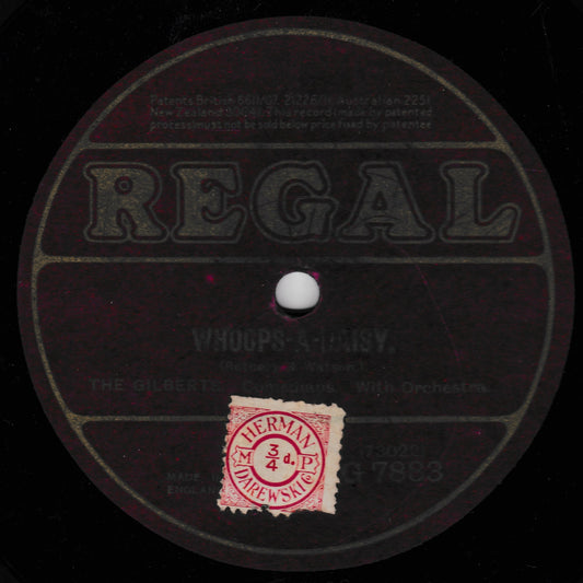 A vintage Regal 78rpm record label for 'Whoops a Daisy' by The Gilberts, featuring a black background with dark printed text and a red circular 78rpm speed record sticker.