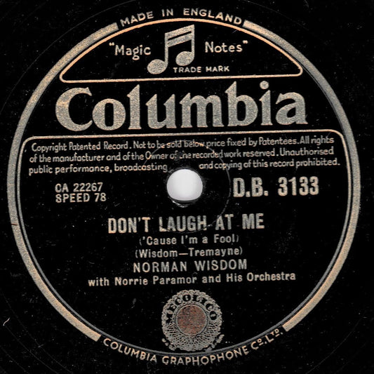 A vintage Columbia record label for 'Don't Laugh At Me' by Norman Wisdom, featuring black shellac with cream-coloured text and border details.