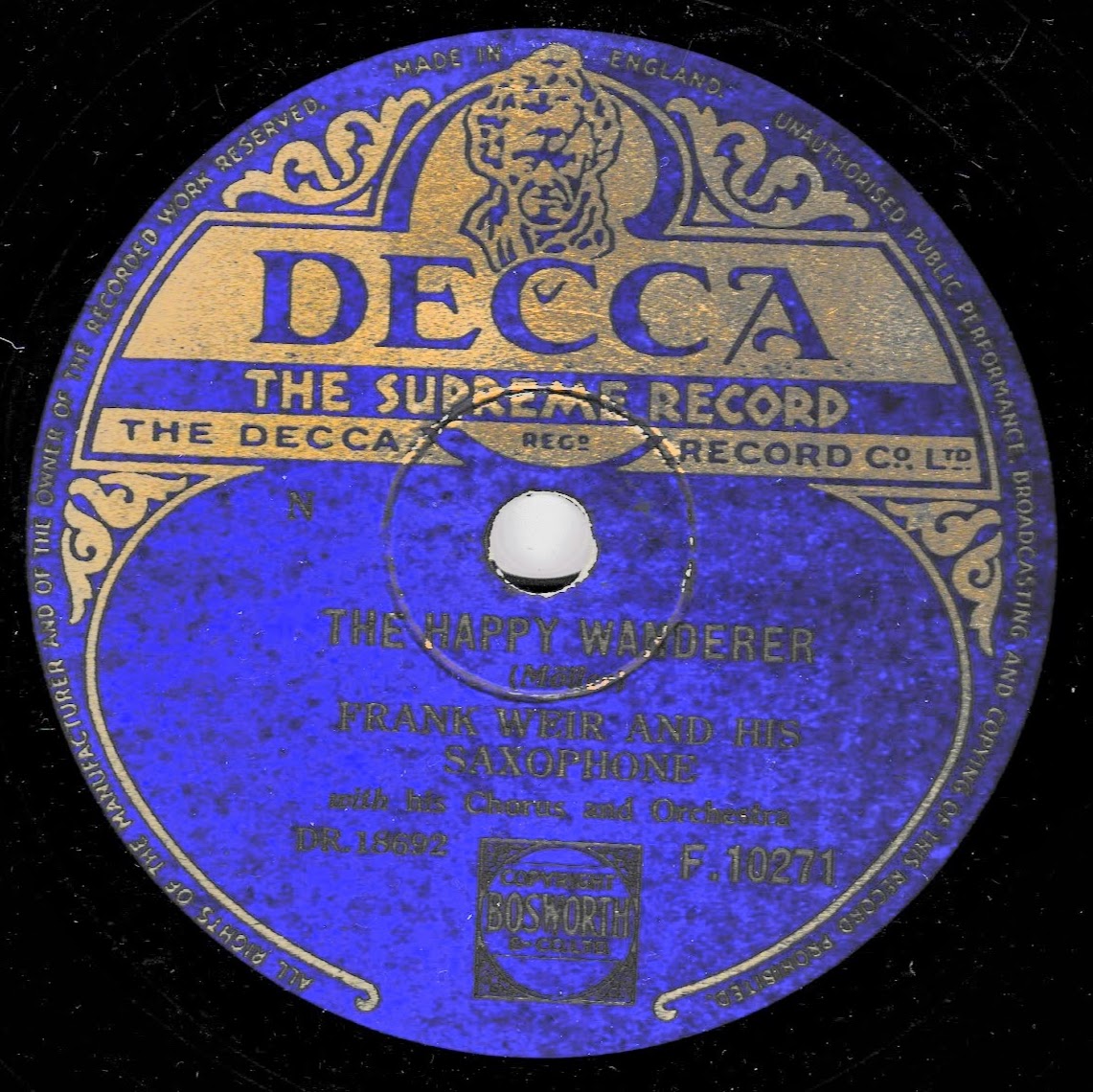 A vintage Decca 10-inch record label for Frank Weir and His Saxophone's 'The Happy Wanderer', featuring a vibrant blue and gold design on a black background.