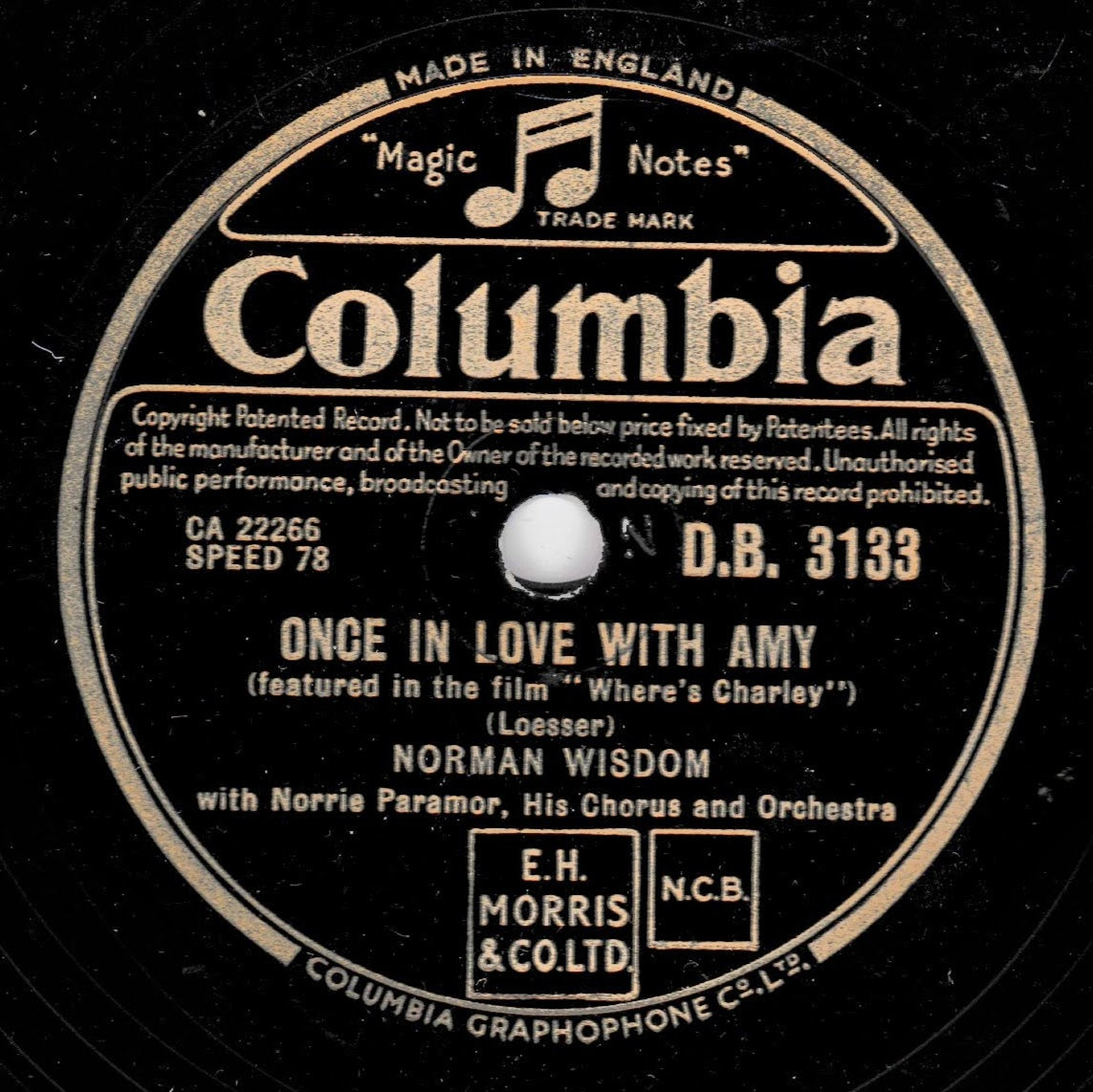A vintage black Columbia record label with cream text and graphics, featuring the song 'Once in Love with Amy' by Norman Wisdom. The label includes the 'Magic Notes' mark and publisher marks.