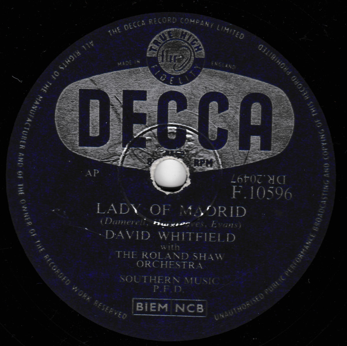A vintage Decca 10-inch shellac record label for David Whitfield's 'Lady of Madrid' with The Roland Shaw Orchestra, featuring a dark blue and black background with silver-gray text and graphics.