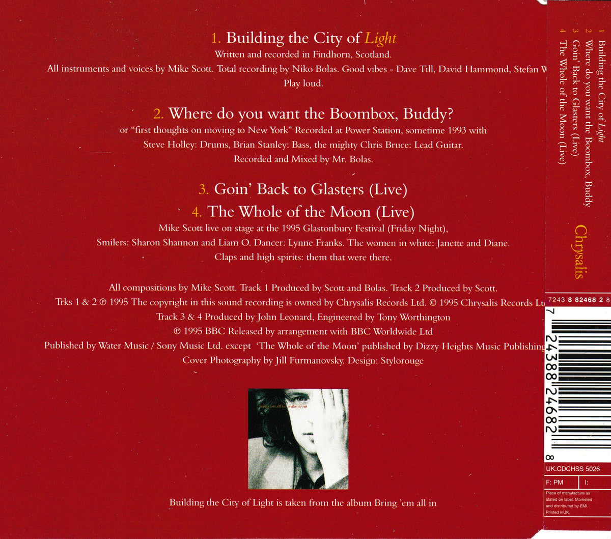 The back cover of the Mike Scott single 'Building the City of Light' on Chrysalis Records, featuring a deep red background with white track listing text and a barcode on the right side.