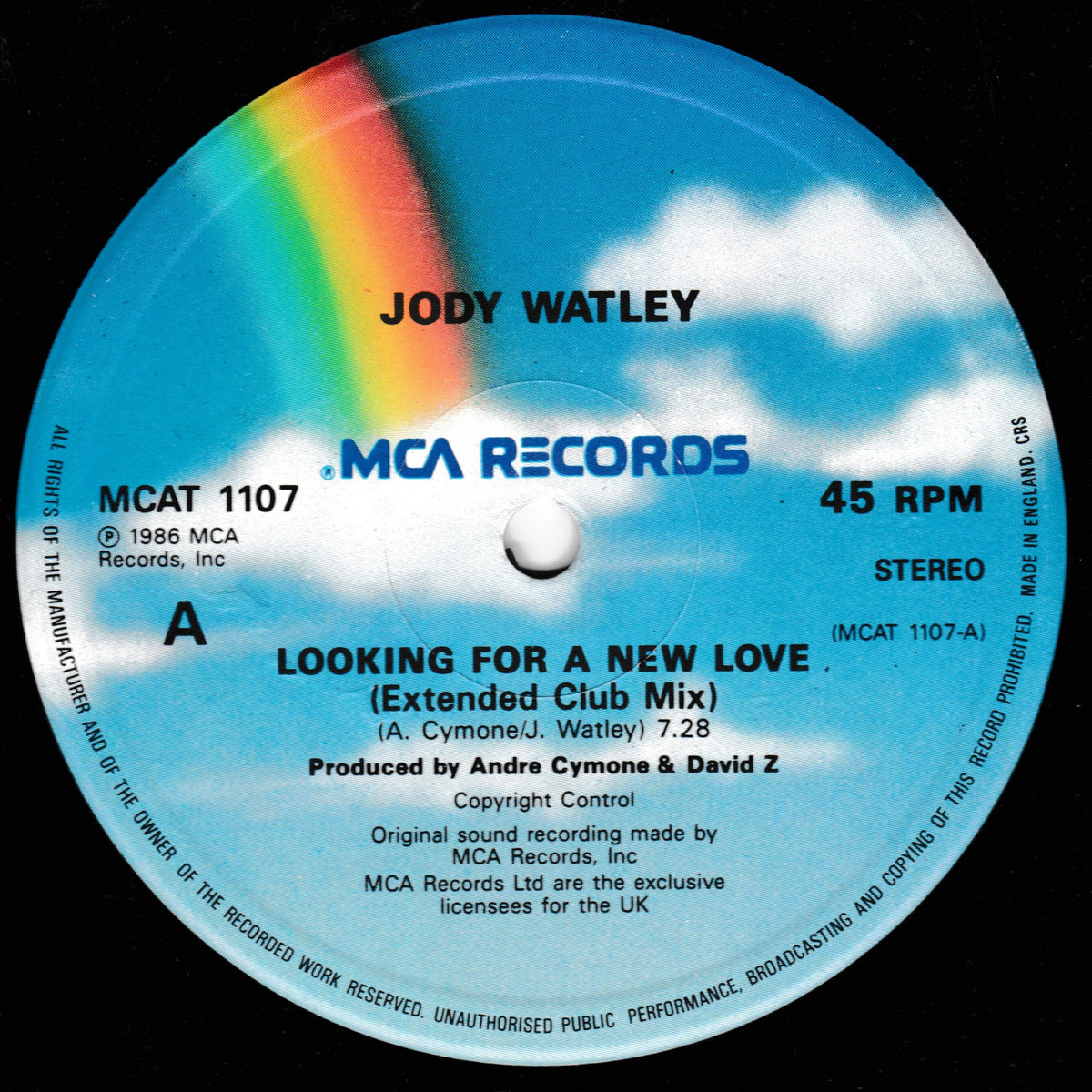 A vinyl record label for Jody Watley's 'Looking For A New Love (Extended Club Mix)' on MCA Records. The label features a sky-blue background with white clouds and a vibrant rainbow arching over the top left corner.