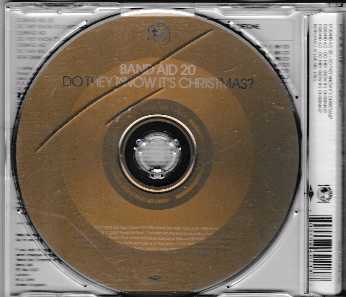 The CD single cover of Band Aid 20's 'Do They Know It's Christmas?' inside its jewel case, featuring a metallic gold disc on a silver plastic case.