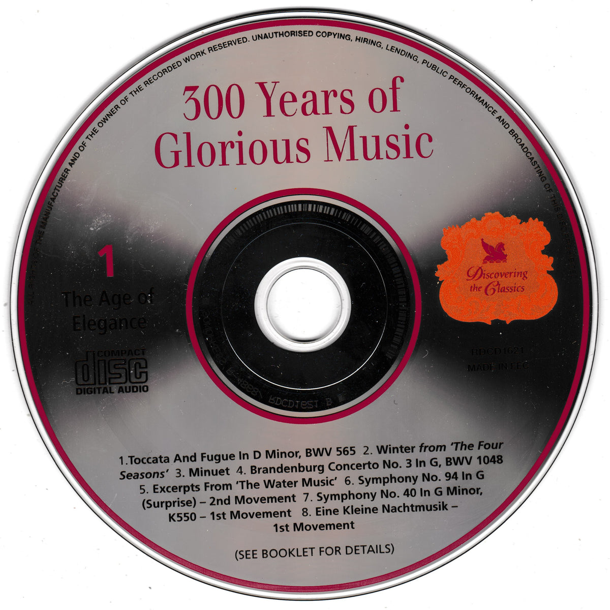 A compact disc with the title '300 Years of Glorious Music' in red text, featuring a black outer ring, pink inner ring, track list at the bottom, and an orange flower-like logo reading 'Discovering the Classics'.