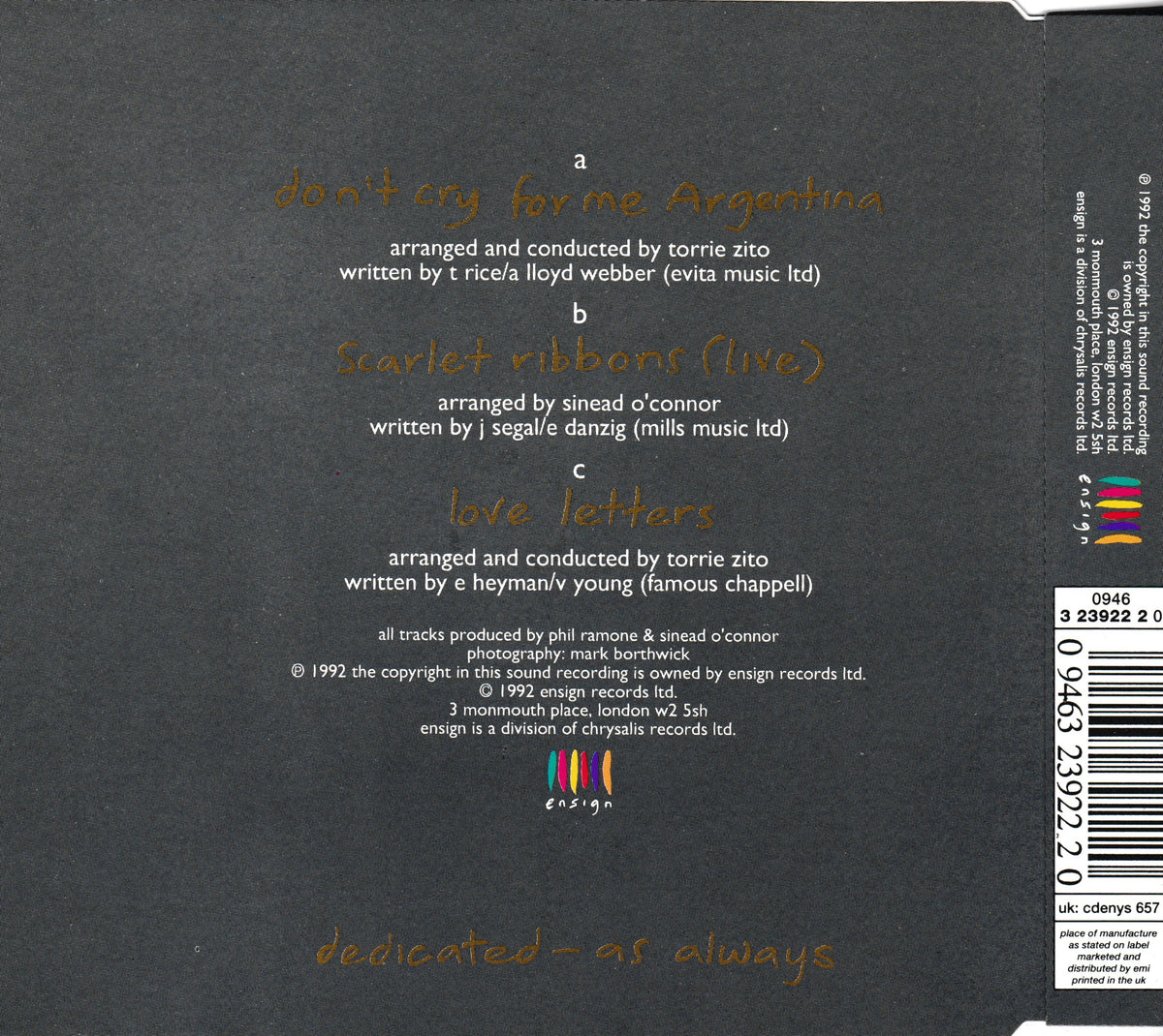 The back cover of a music CD, featuring track listings for 'Don't Cry For Me, Argentina', 'Scarlet Ribbons (live)', and 'love letters' in gold text on a dark charcoal background, with a barcode and catalog info on the right side.