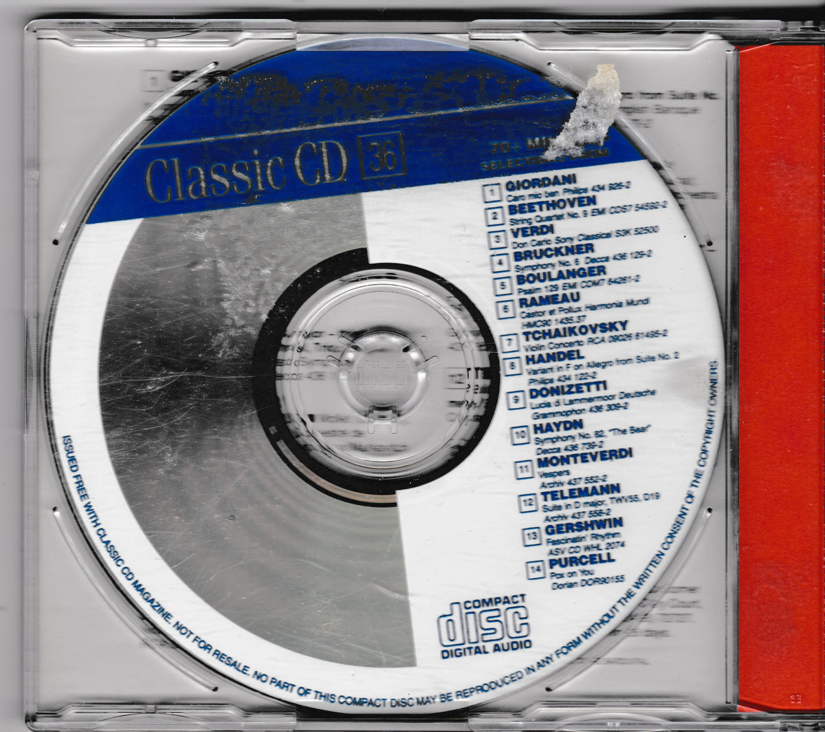 A classic CD jewel case containing a silver reflective disc with a blue and white label, printed with classical music repertoire track listings, with a red side insert visible on the right.