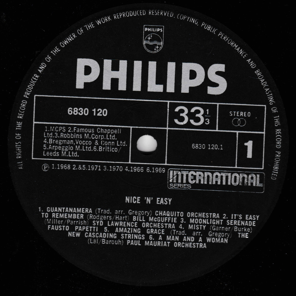 A close-up of a black vinyl record label with white text. The prominent brand visible is Philips, with additional text including 'International Series', catalog number 6830 120, and the LP title 'Nice 'N Easy' with a list of credited performers and composers.
