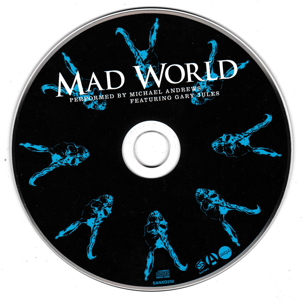 A compact disc with a black printed background, silver outer rim, and blue stylized skeletal figures arranged around the disc. Large white text reads “MAD WORLD,” with smaller text below reading “PERFORMED BY MICHAEL ANDREWS FEATURING GARY JULES.