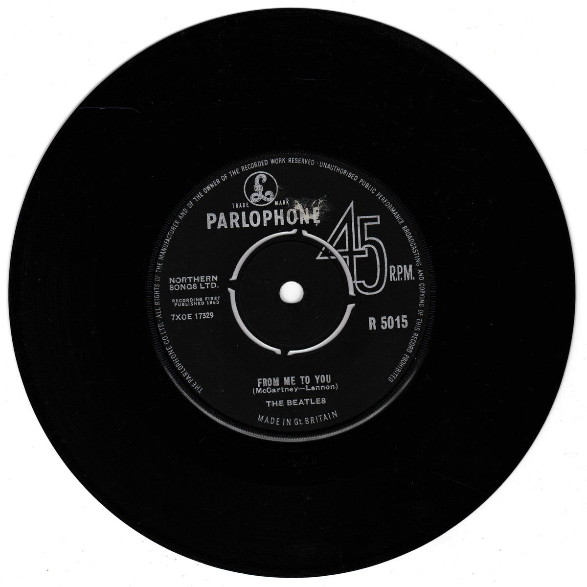 A black 45 RPM vinyl record with a white Parlophone centre label, featuring the Beatles' song 'From Me To You'.