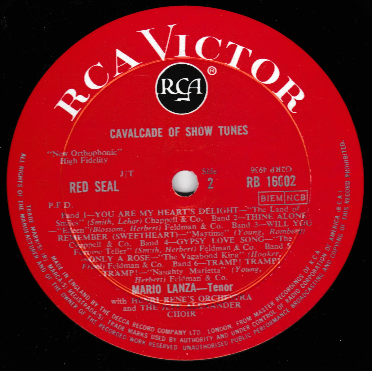 A close-up of a red RCA Victor record label with white text, featuring the artist name Red Seal and track listings for 'Cavalcade of Show Tunes' on a black background.