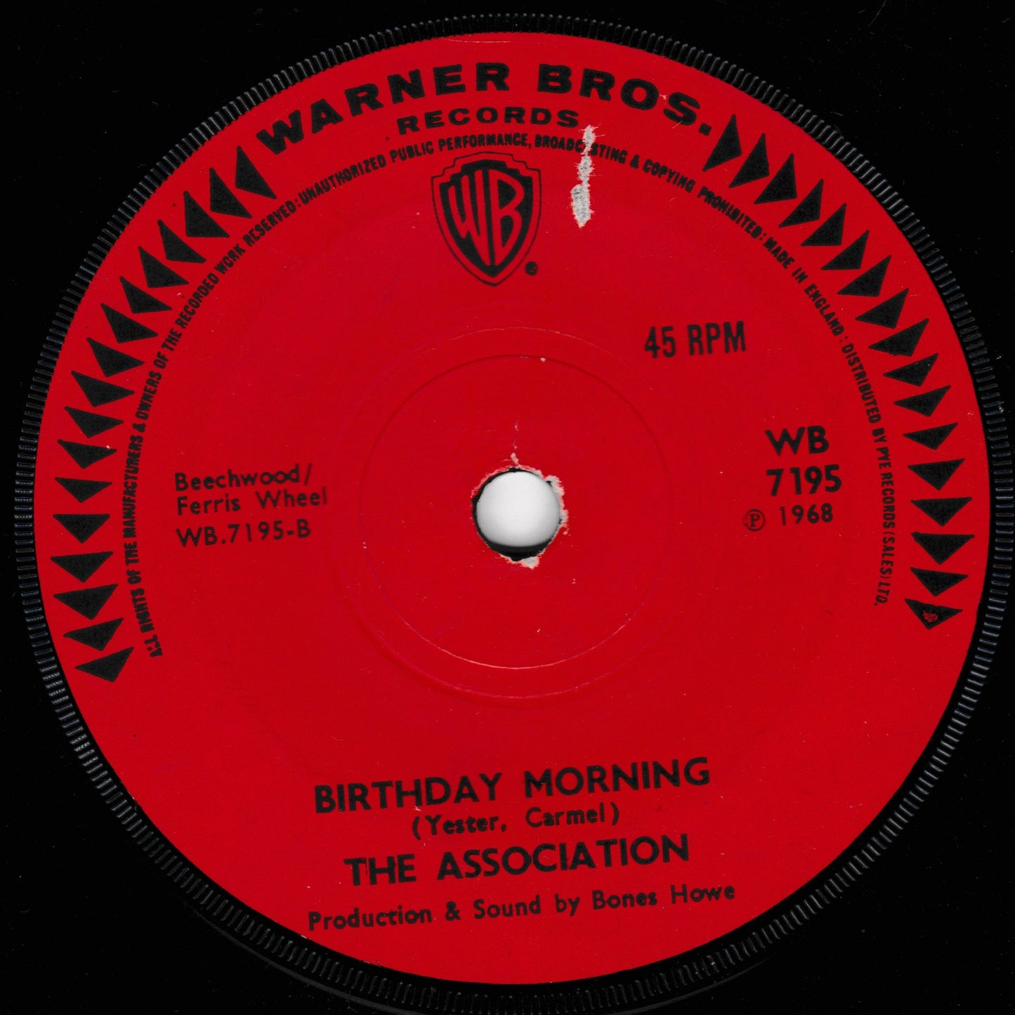 A red 45 RPM vinyl record label from Warner Bros. Records featuring the song 'Birthday Morning' by The Association, with the Warner Bros.