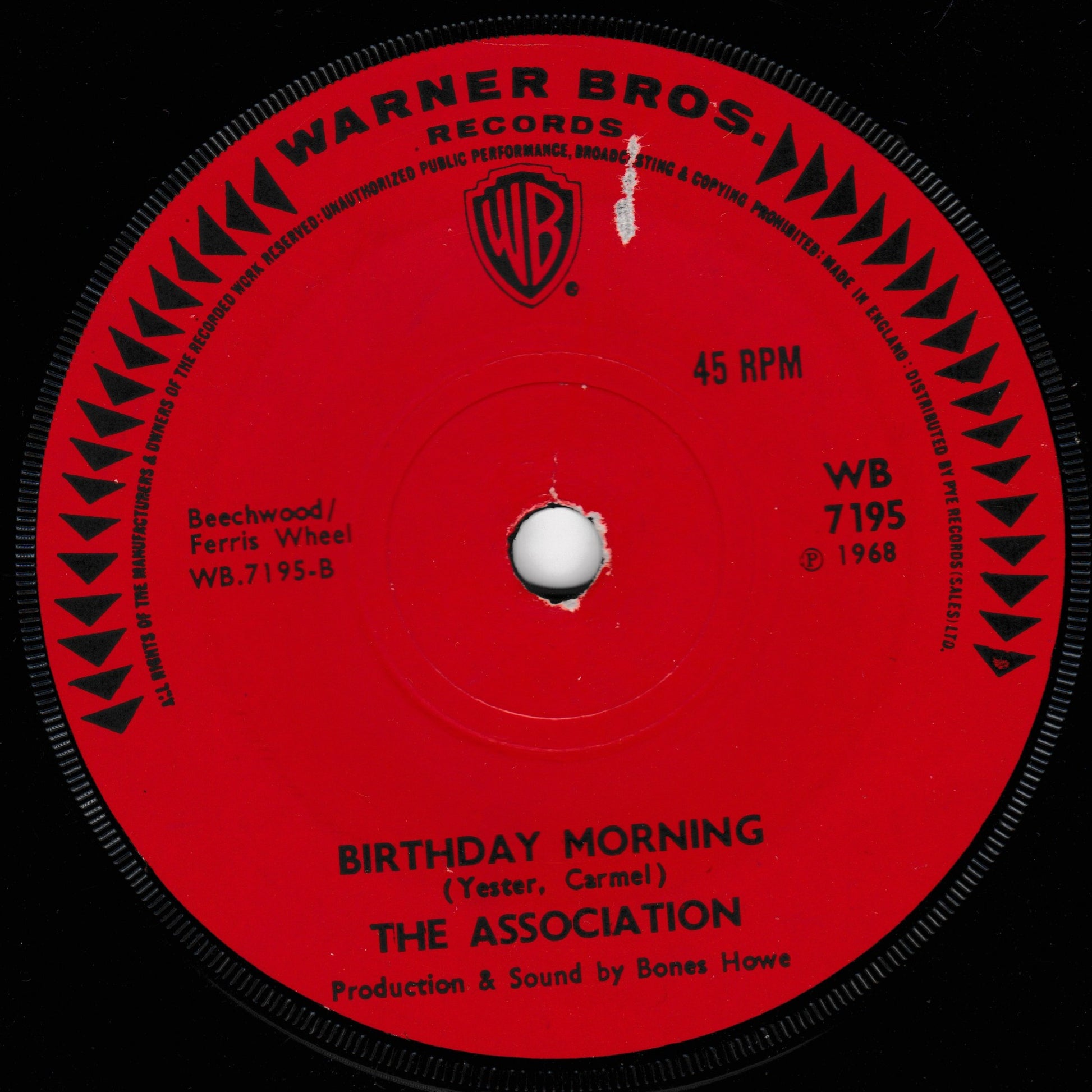 A red 45 RPM vinyl record label from Warner Bros. Records featuring the song 'Birthday Morning' by The Association, with the Warner Bros.