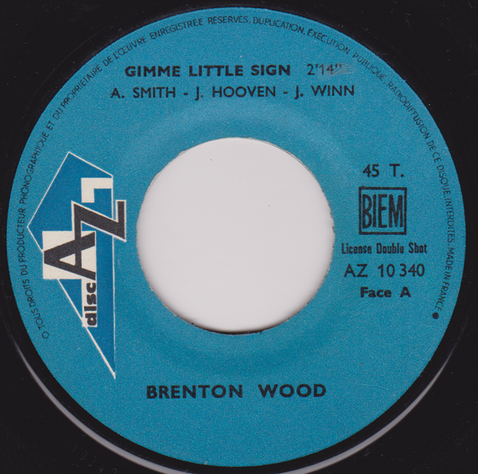 Record label with blue background and white center, featuring text and logos.