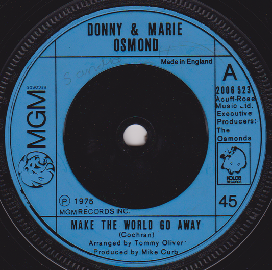 Record label for Donny & Marie Osmond's 'Make the World Go Away' with MGM logo.