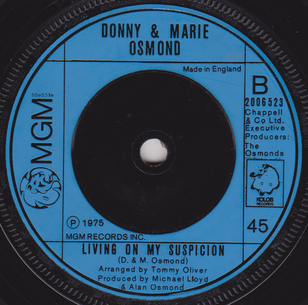 Record label for Donny & Marie Osmond's 'Living on My Suspicion' with blue background and black text.