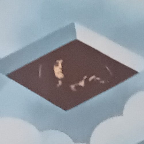 Roger Daltrey inside a rectangular hole with a light blue background