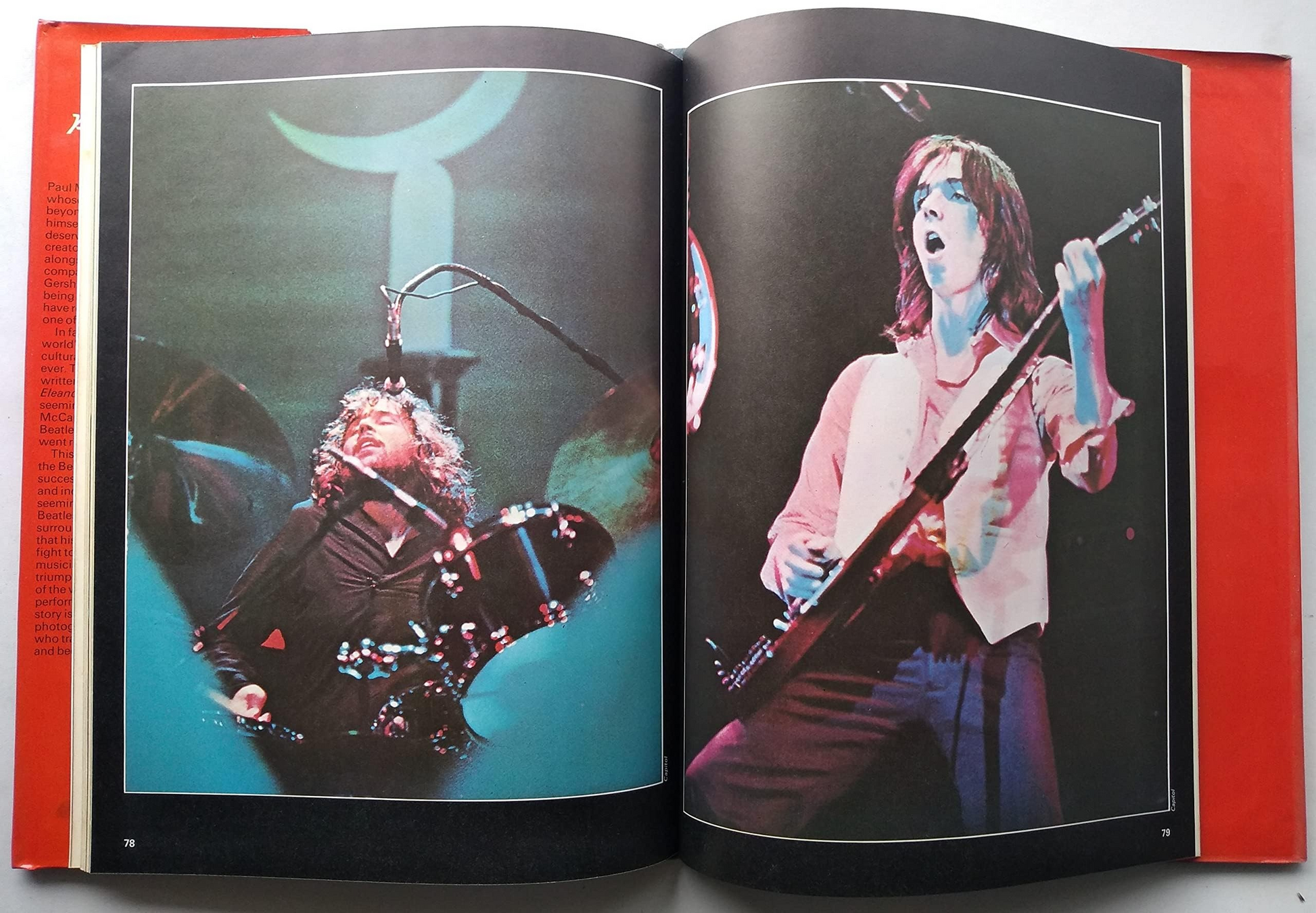 An open book spread showing two printed concert photographs side by side, with red-orange page edges visible around the pages.